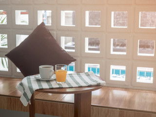 cup of hot coffee and orange juice in the morning