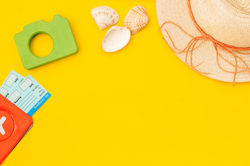 Funny vocation concept with camera, hat, passport and tickets on yellow background top view space for text