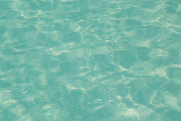 Blue pool water with sun reflections