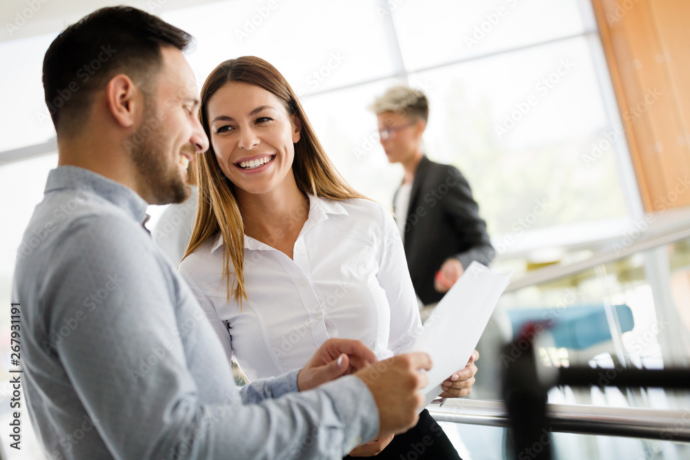 Poster picture of business colleagues talking in office