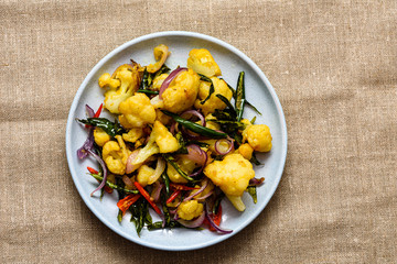 Freshly made spicy fried cauliflower, isolated.