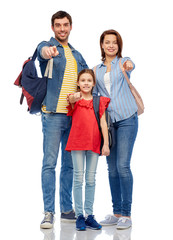 family, tourism and travel concept - happy smiling mother, father and little daughter with backpacks pointing finger to you over white background