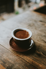 cup of coffee on wooden table