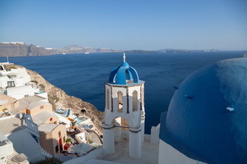 Fototapeta na wymiar Oia in Santorini in summer with a view of the blue domes