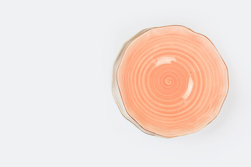 Simple rustic handmade dish on a white background. top view