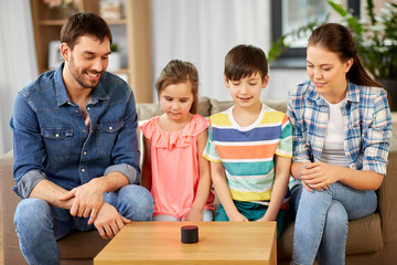 family, technology and internet of things concept - happy father, mother, little son and daughter...