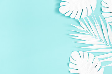 Summer composition. White palm leaves on blue background. Summer concept. Flat lay, top view, copy...