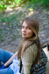 beautiful blue eyed girl sitting on stairs in a summer park