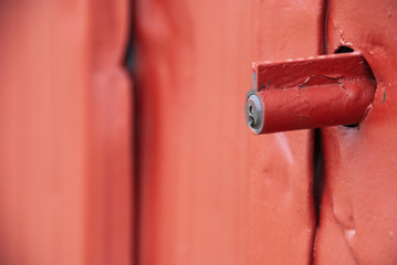 Detail of a metal workhouse lock in red