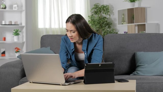 Worried woman using multiple devices and calling on phone