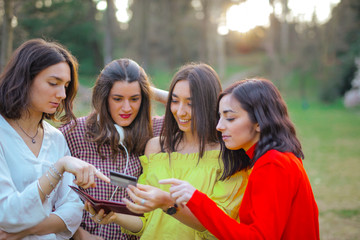 Young female friends looking something together in nature
