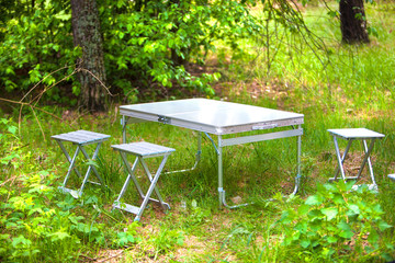 metal folding table and chairs for a picnic in nature