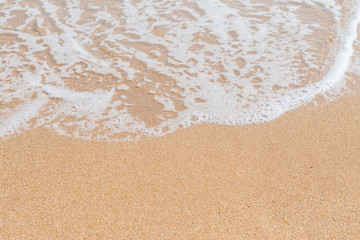 Wave of the sea on the sandy beach