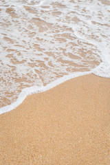 Fototapeta na wymiar Wave of the sea on the sandy beach