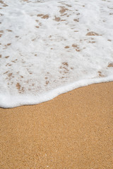 Wave of the sea on the sandy beach
