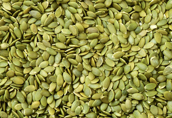 Macro background texture of green pumpkin seeds