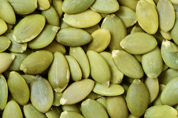 Macro background texture of green pumpkin seeds