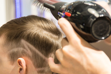 Fototapeta premium Hairdresser cutting hair. Hairdresser at work cutting customers hair