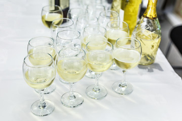 lot of blurred glasses with champagne on the reception party table