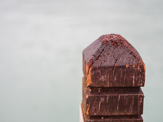Closeup grunge wooden pole head at the pier with copy space.