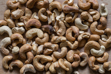 Cashews on a wooden surface. Roasted Cashew Nuts