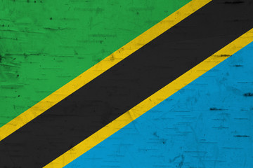 A rustic old Tanzania flag on weathered wood