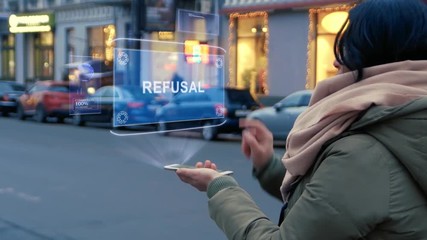 Unrecognizable woman standing on the street interacts HUD hologram with text Refusal. Girl in warm clothes uses technology of the future mobile screen on background of night city
