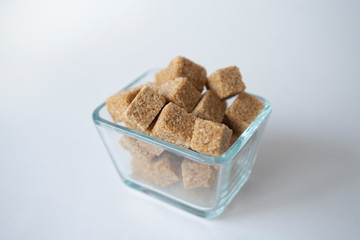 pieces of cane sugar are in a glass