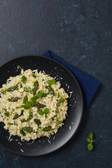 Classic Italian risotto with asparagus. Top view. Darkblue background.