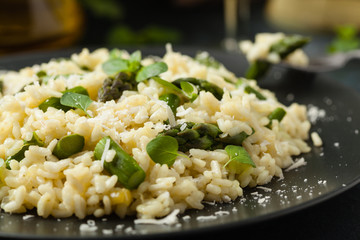 Classic Italian risotto with asparagus. Front view. Darkblue background.