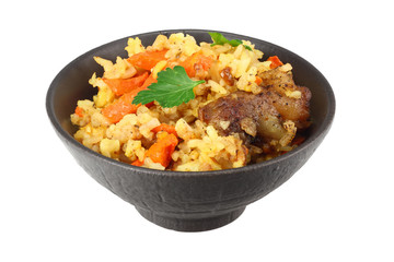 pilaf with meat in black bowl isolated on white background
