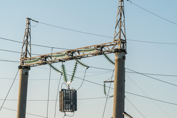 wires attached to the electric mast. The chaos of cables and wires on an electric pole. Many...