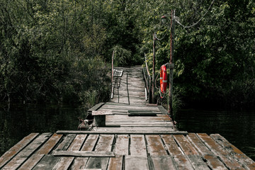 Wooden pier with a bright orange lifebuoy