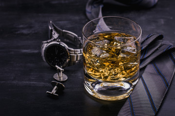 Male concept for father's day. Tie, watches, cufflinks and a glass of whiskey with ice