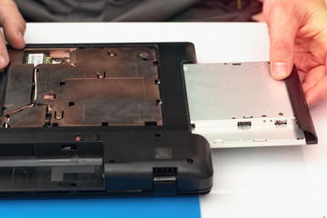 Engineer dismantles the details of a broken laptop for repair