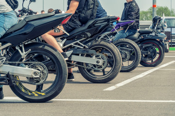 Four motorcycles are unlikely. Rear wheels of motorcycles close up