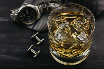 Male concept for father's day. Tie, watches, cufflinks and a glass of whiskey with ice