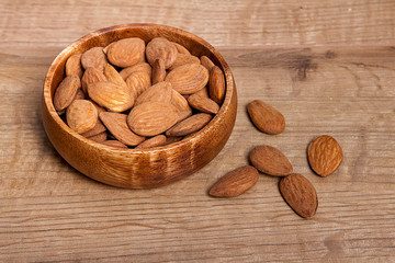 Almond in a bowls on wooden table. Healthy food and snack.