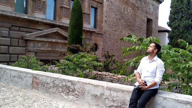 Male turist visiting ancient monument in Alhambra Granada