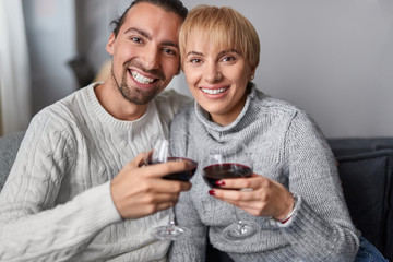 Fototapeta premium Happy couple clinking glasses during date