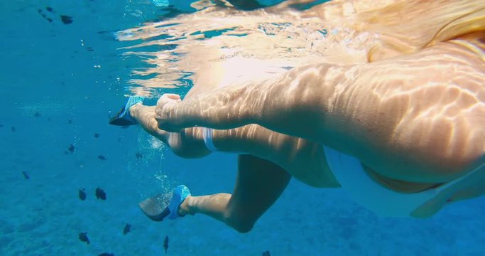 POV of beautiful young woman snorkeling
