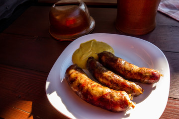 Three boiled pork sausage on plate on table.