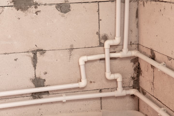 Heating pipes on the wall in a house under construction