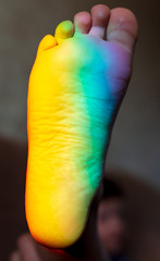 Man's foot in the color of the rainbow