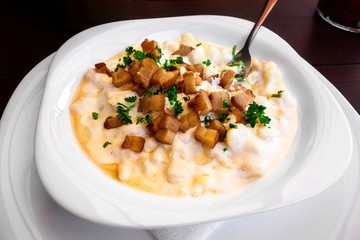 Potato dumpling in cream cheese, diced bacon.