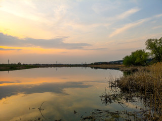 Fototapeta na wymiar Sunset over the lake in nature