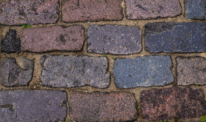 The texture of the pavement of old cobblestones.
