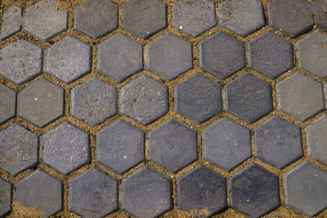 The texture of the pavement of the paving stones in the form of honeycombs.