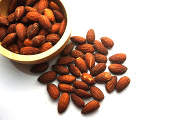 Almond tablets mixed with salt in a wooden cup.