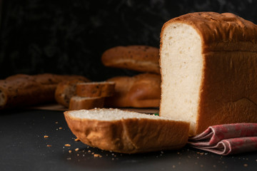 freshly baked sliced white bread with metal knife, toasts for cooking sandwitchs